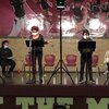 Students standing on a stage